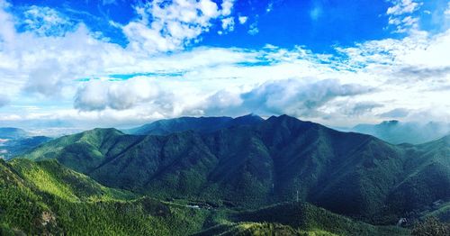 Scenic view of mountains against blue sky