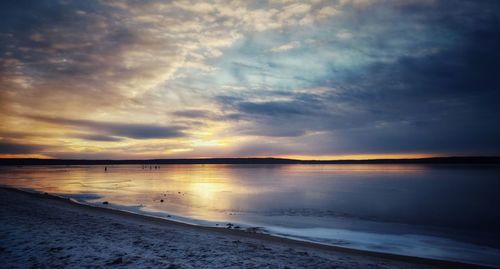 Scenic view of beach against sky during sunset