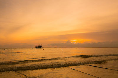 Scenic view of sea against orange sky