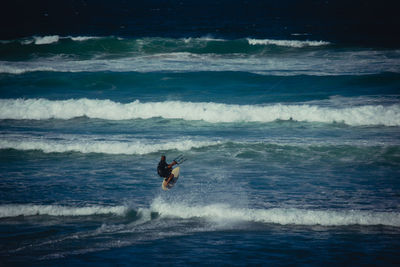 Man kitesurfing in sea