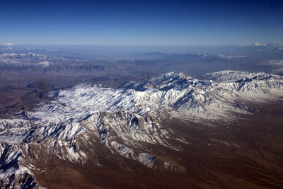 High angle view of snowcapped mountains against sky