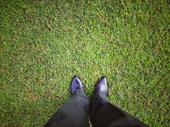 Low section of man standing on field