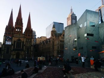 Group of people in front of buildings