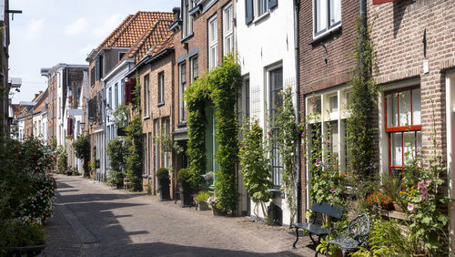 Empty road amidst buildings in town