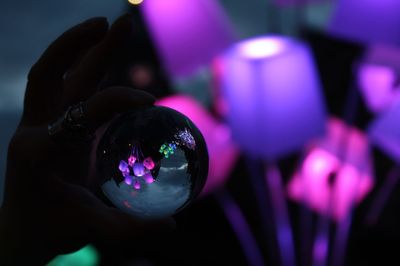 Close-up of hand holding illuminated ball