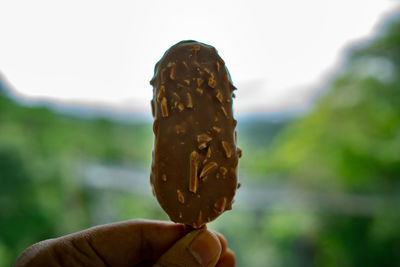 Close-up of hand holding ice cream