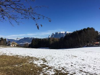 Scenic view of snowcapped mountains against clear blue sky