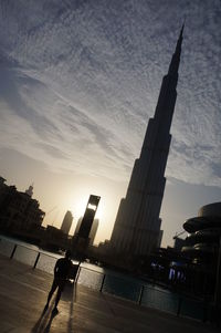 People walking in city at sunset