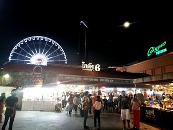 People in illuminated city at night