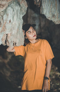 Portrait of young man standing on rock