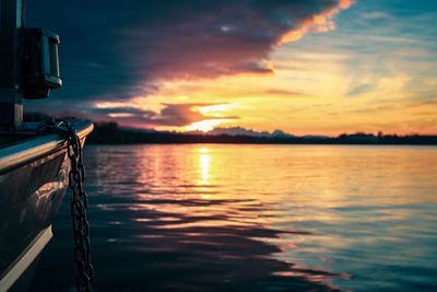 Sailboat sailing on sea against sky during sunset