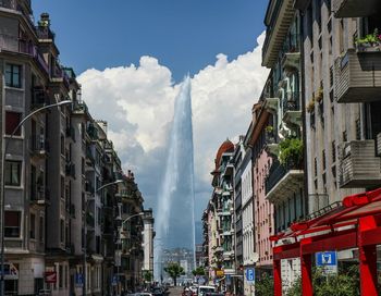 Fountain amidst buildings against sky in city