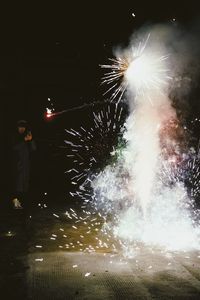 Low angle view of firework display at night