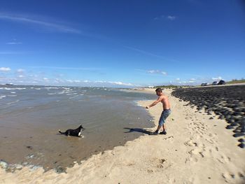 Rear view of boy walking on beach