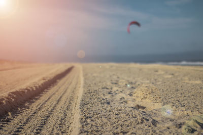 Surface level of sand on beach against sky