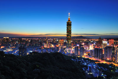 Taipei 101 against blue sky in city at dusk