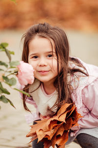 Portrait of smiling girl with leaves