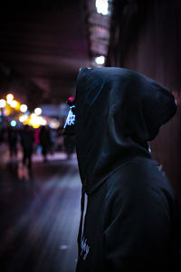 Midsection of person in illuminated street at night