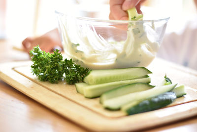 Midsection of person preparing food on cutting board