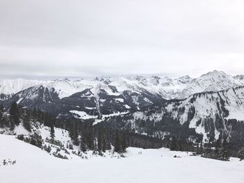 Scenic view of snow mountains against sky