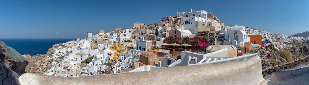 Panoramic view of buildings against blue sky