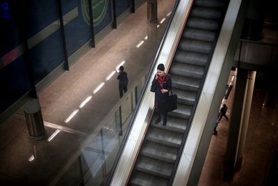 High angle view of people walking on escalator