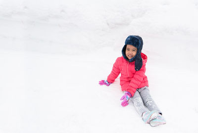 Girl wearing hat against snow during winter