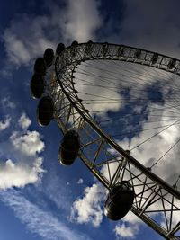 Low angle view of ferris wheel against blue sky