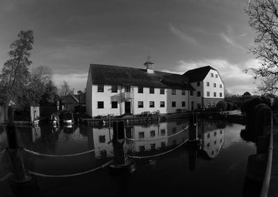 Canal amidst buildings against sky