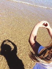 Shadow of man on sand at beach