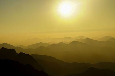 Scenic view of silhouette mountains against sky during sunset