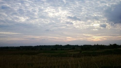 Scenic view of field against sky during sunset