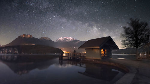 Scenic view of lake against sky at night