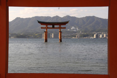 Scenic view of sea and mountains against sky