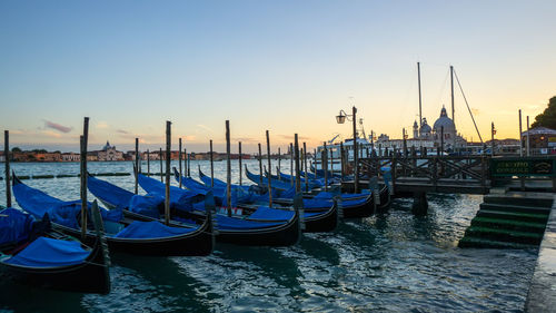 Sailboats moored in canal
