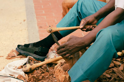 Low section of people working on barbecue grill