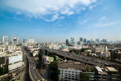 High angle view of street amidst buildings against sky