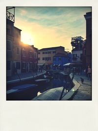 Buildings in city at sunset