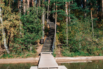 Wooden staircase descending to wooden pier on lake baltieji lakajai in labanoras regional park