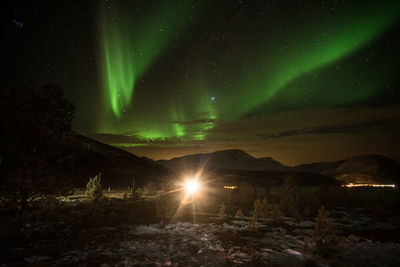 Scenic view of illuminated light against sky at night