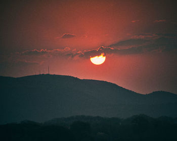 Scenic view of silhouette mountain against romantic sky at sunset