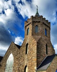 Low angle view of building against cloudy sky