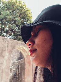 Close-up of young woman wearing hat