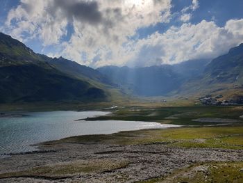 Scenic view of land and mountains against sky