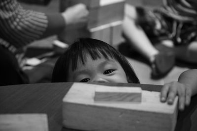 Portrait of cute girl playing with block