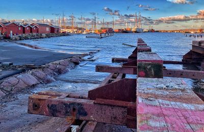 Pier by sea against sky in city