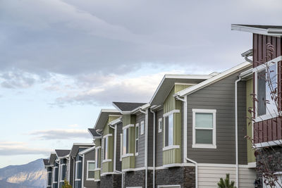 Low angle view of buildings against cloudy sky