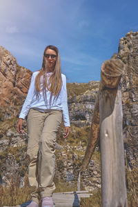 Young tourist walks on a path to the mountain. adventure travel, hiking concept.