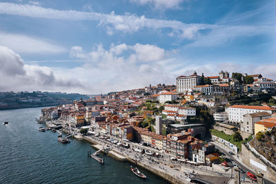 High angle view of townscape by sea against sky