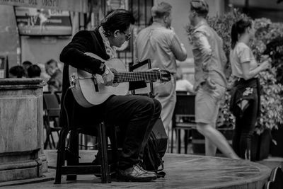 People playing guitar at music concert